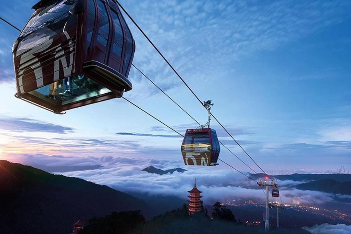 two ski lifts flying over a mountain with clouds