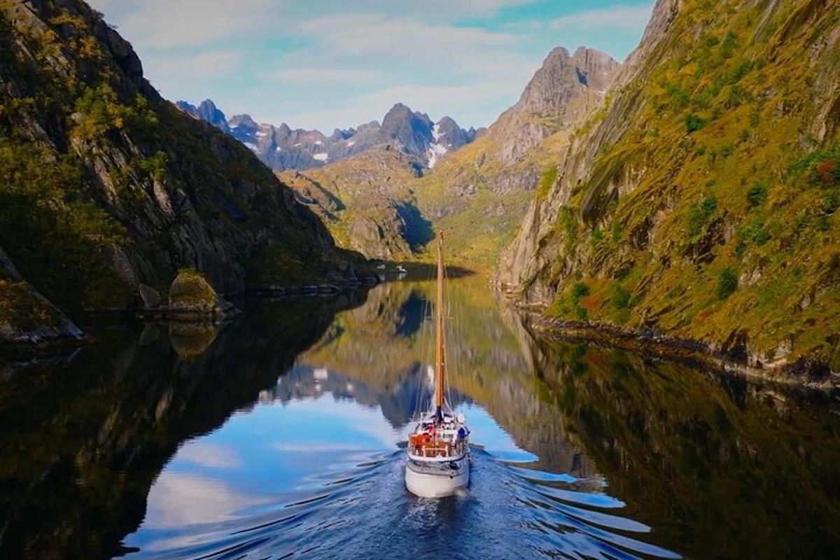 a boat in a river between two mountains