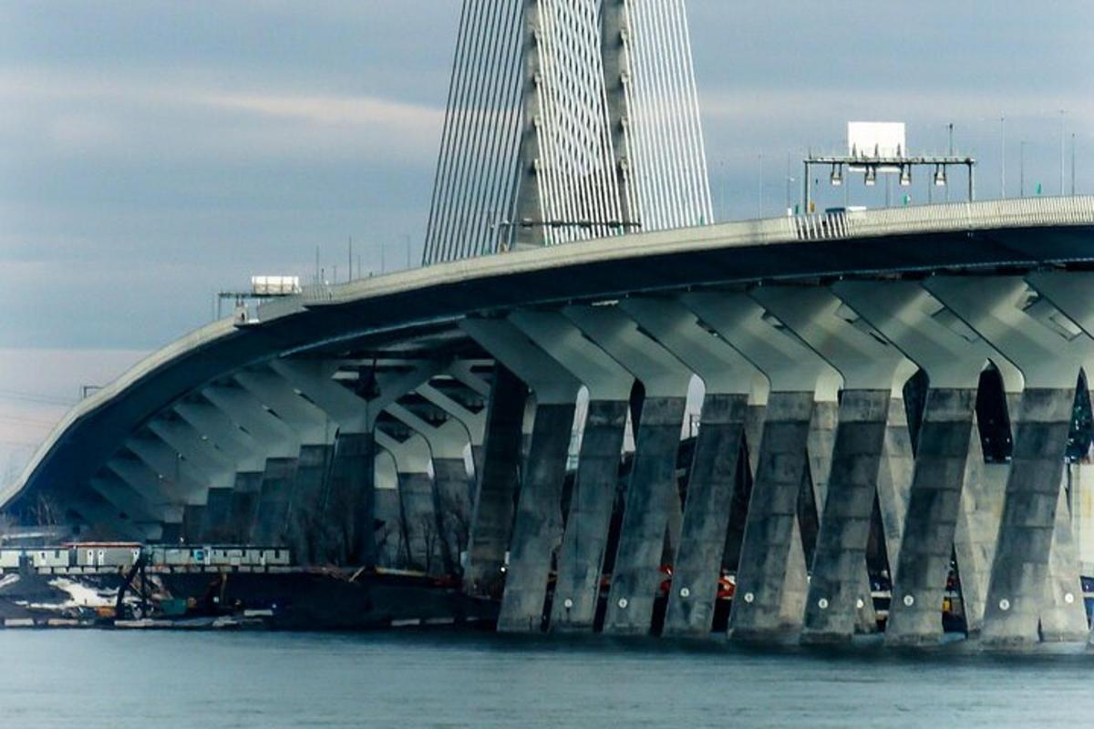 a bridge over the water with a tall building