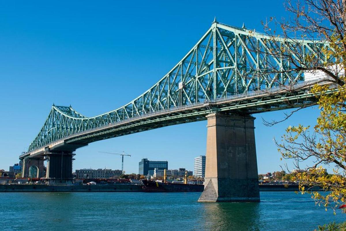 a bridge over the water with a city in the background