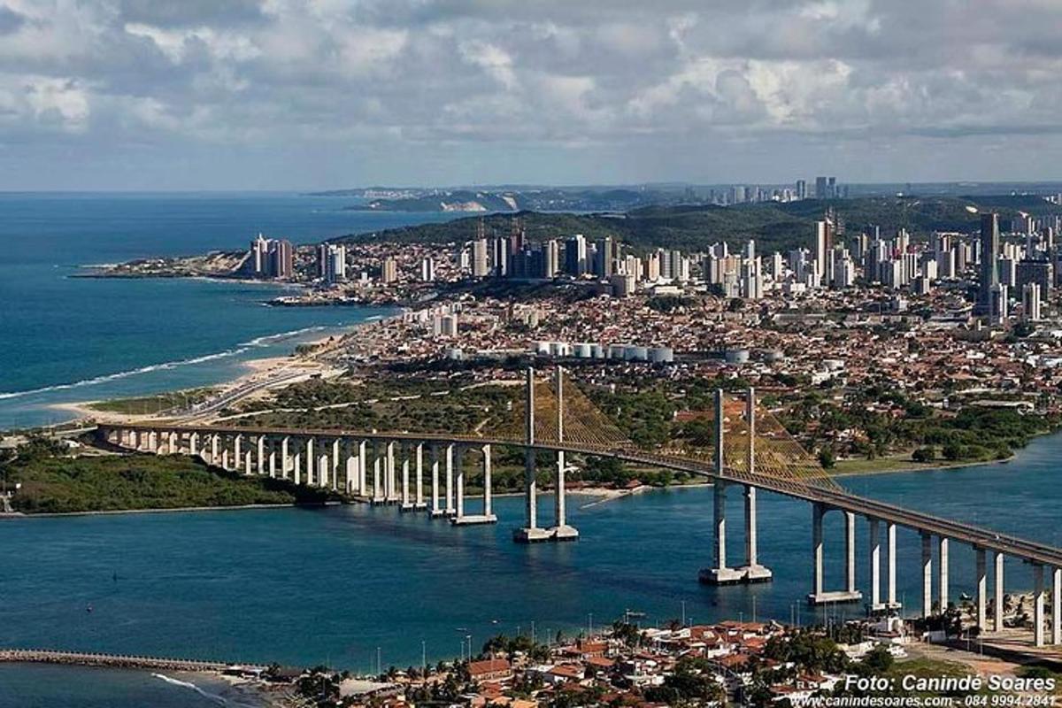 a bridge over a body of water with a city