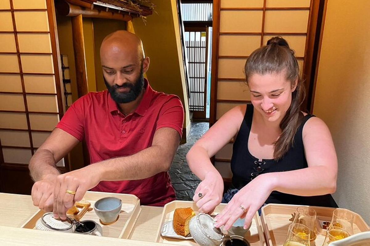 a man and a woman preparing food at a table