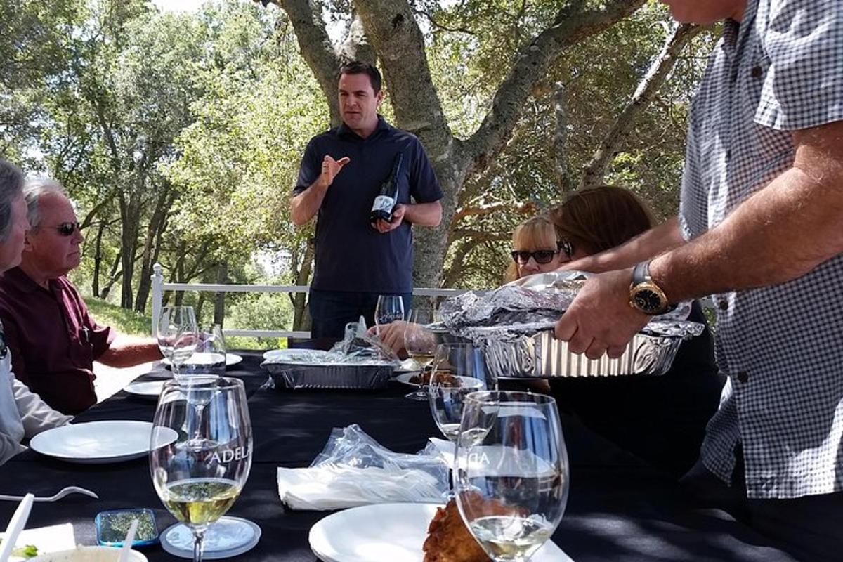 a group of people sitting around a table with wine glasses