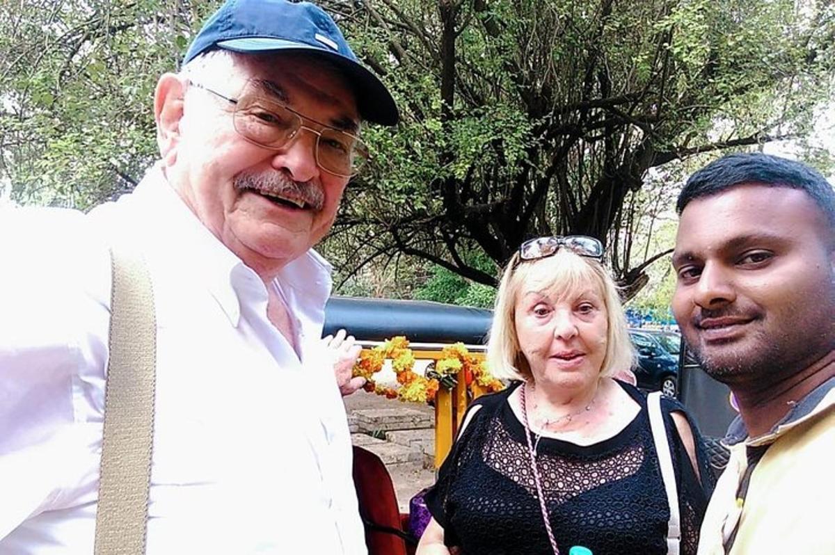 two men and a woman posing for a picture