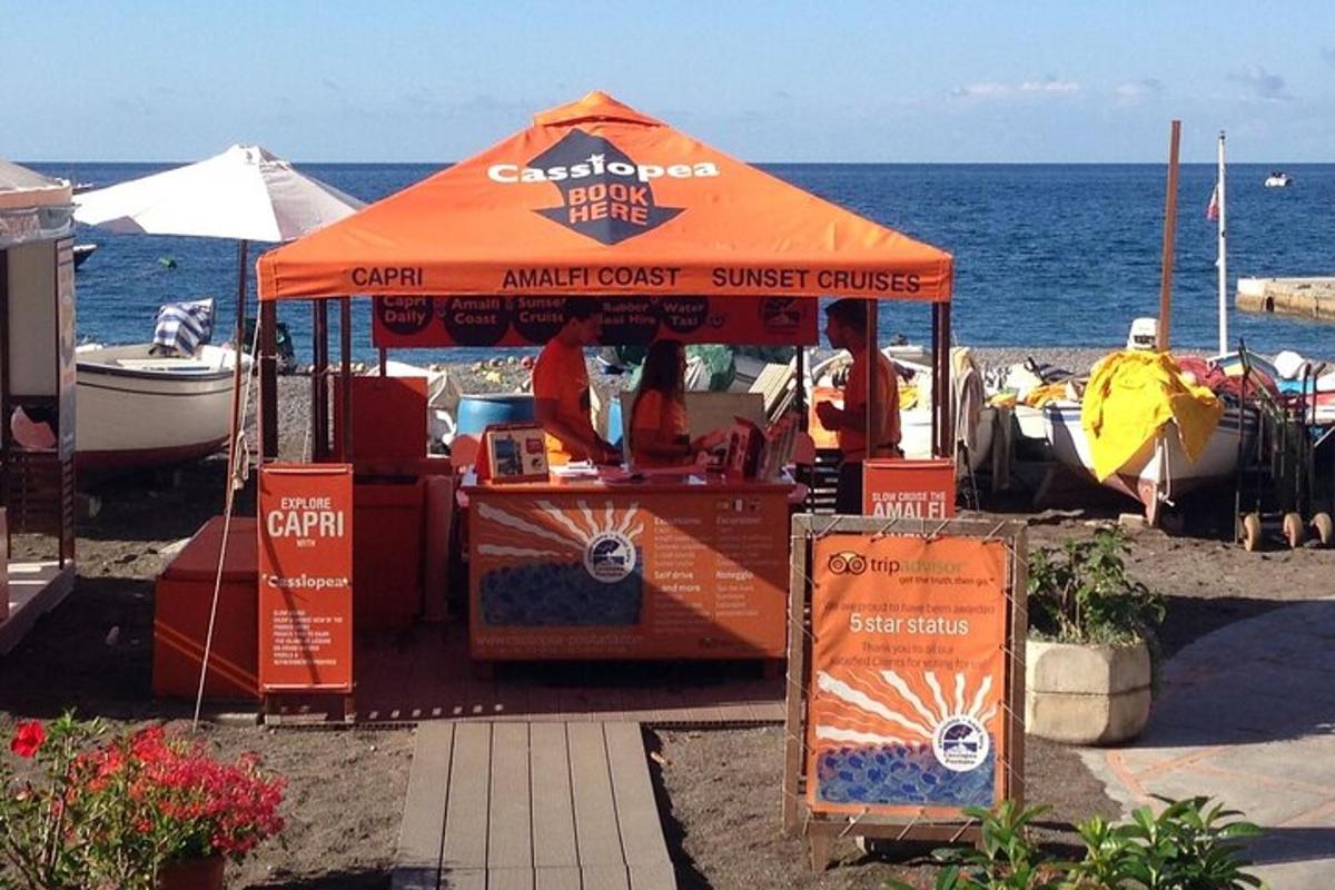 un chiosco di cibo arancione sulla spiaggia vicino all'acqua