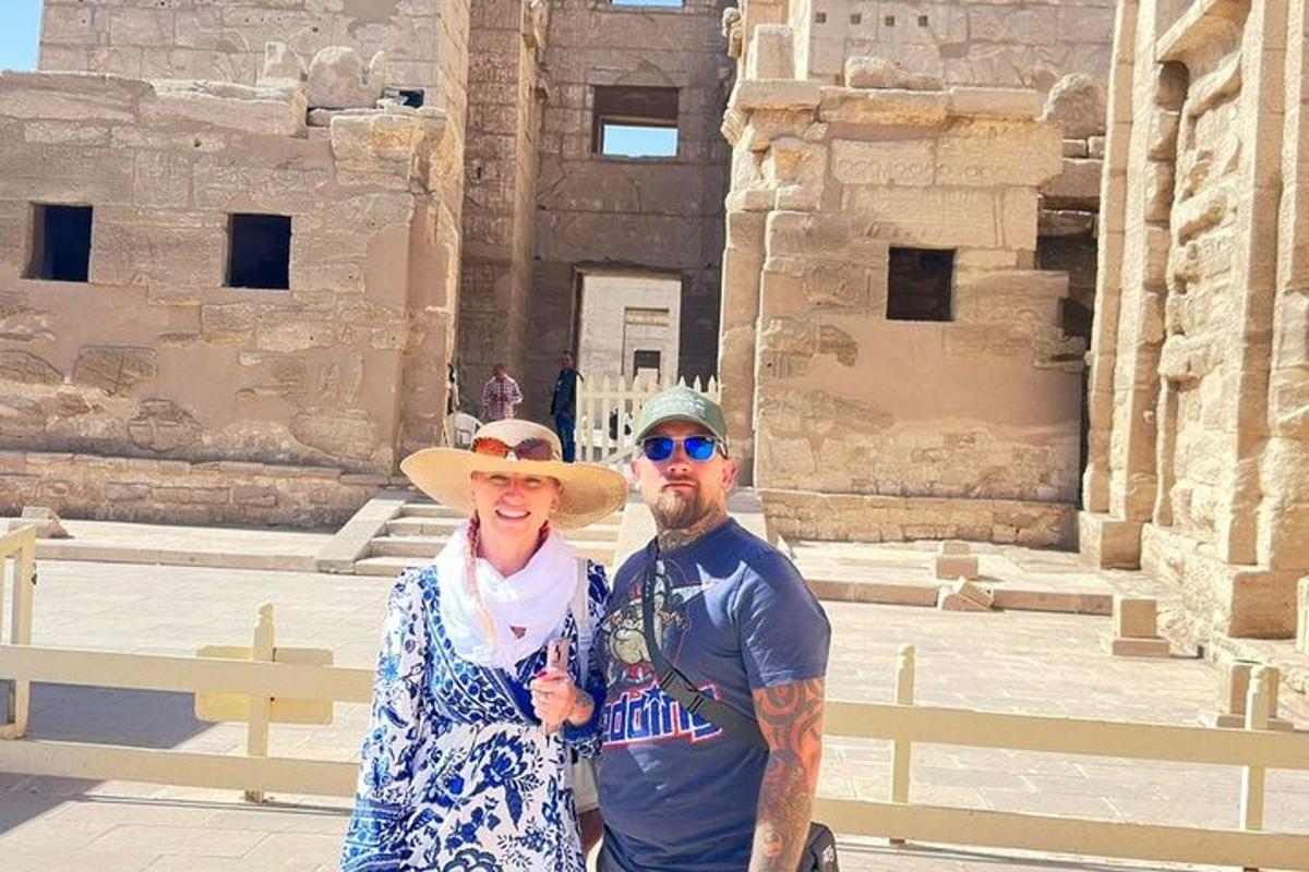 a man and a woman standing in front of a building