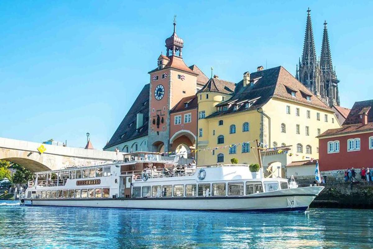 a white boat in the water in front of buildings