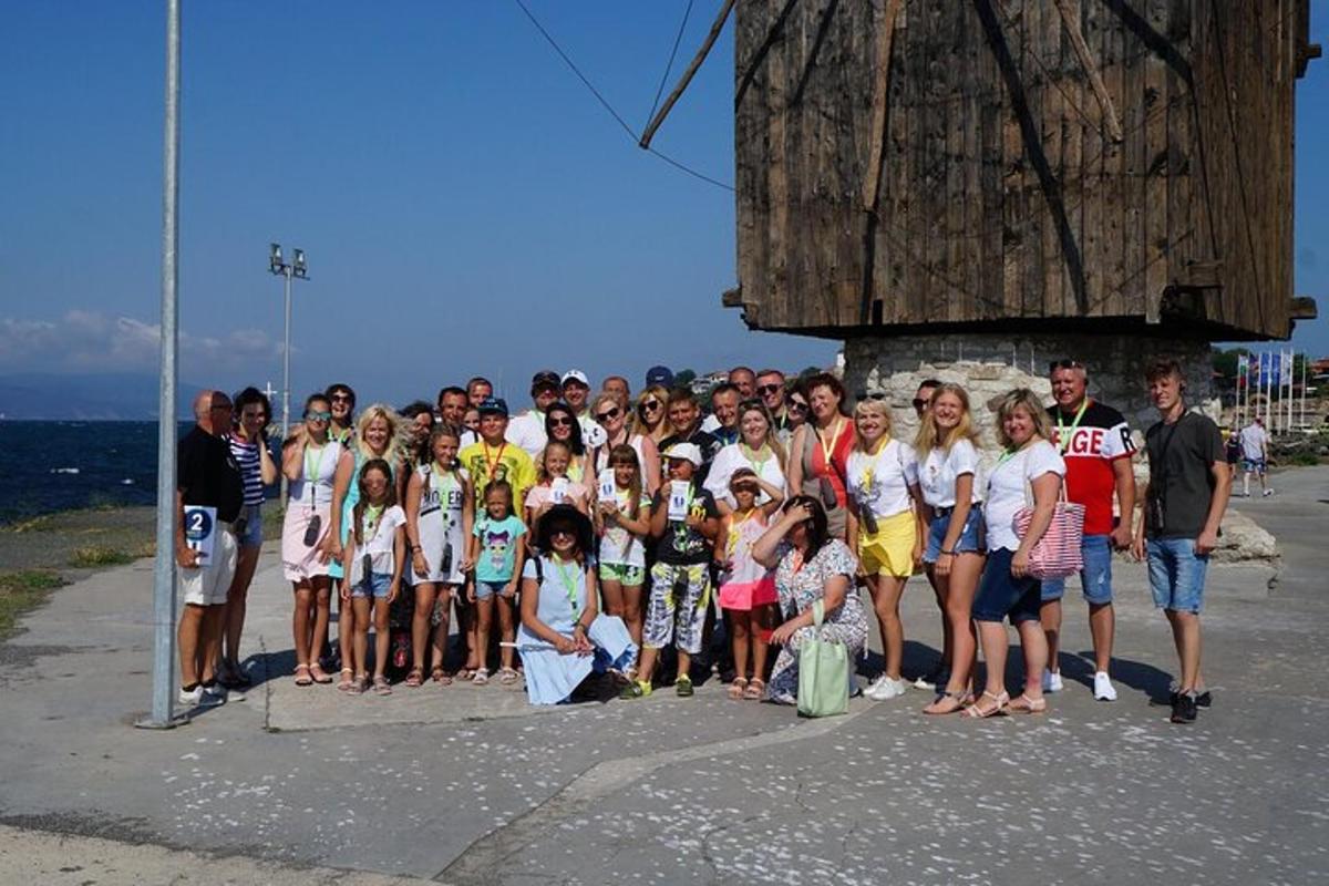 a group of people posing for a picture on the beach
