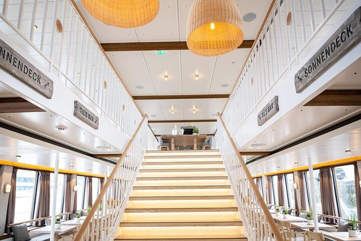 a staircase in a building with tables and chairs
