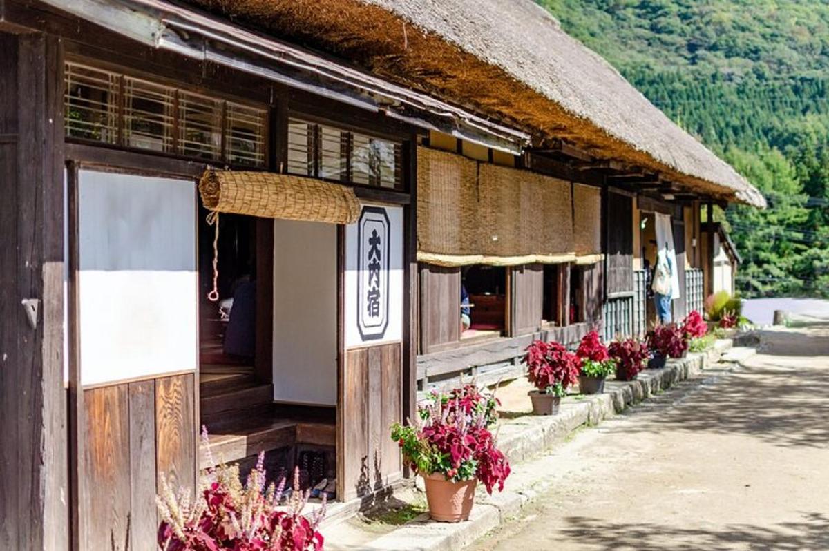 a building with flowers in pots outside of it