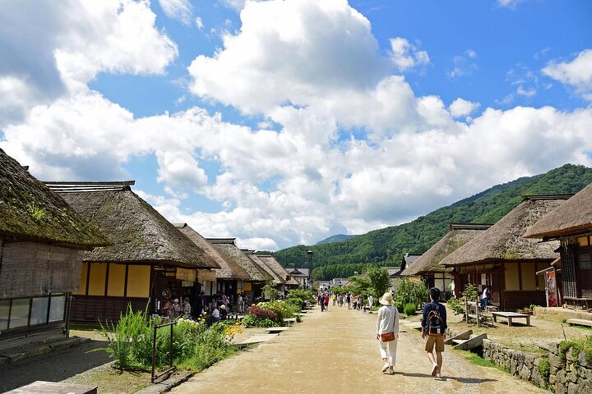 a group of people walking down a street in a village