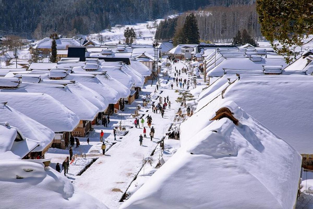a group of people walking down a snow covered slope