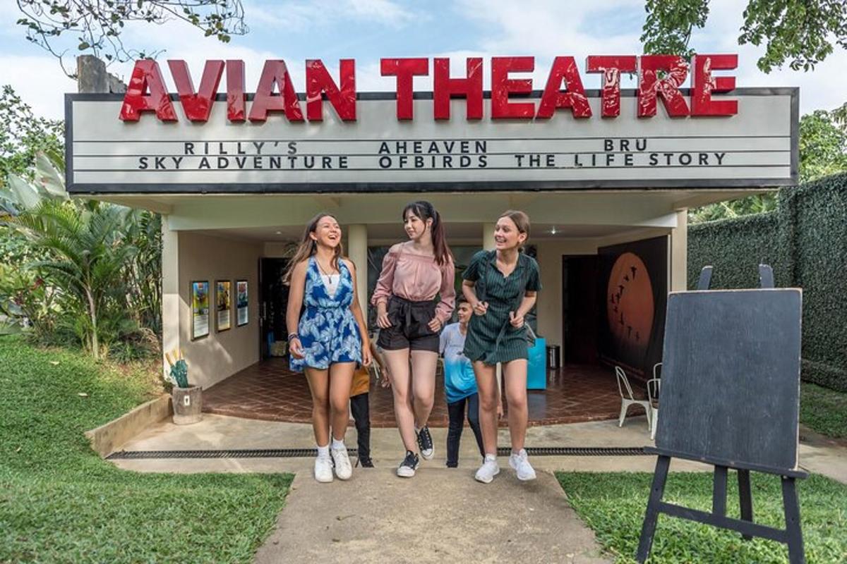 three women standing in front of a aman theatre