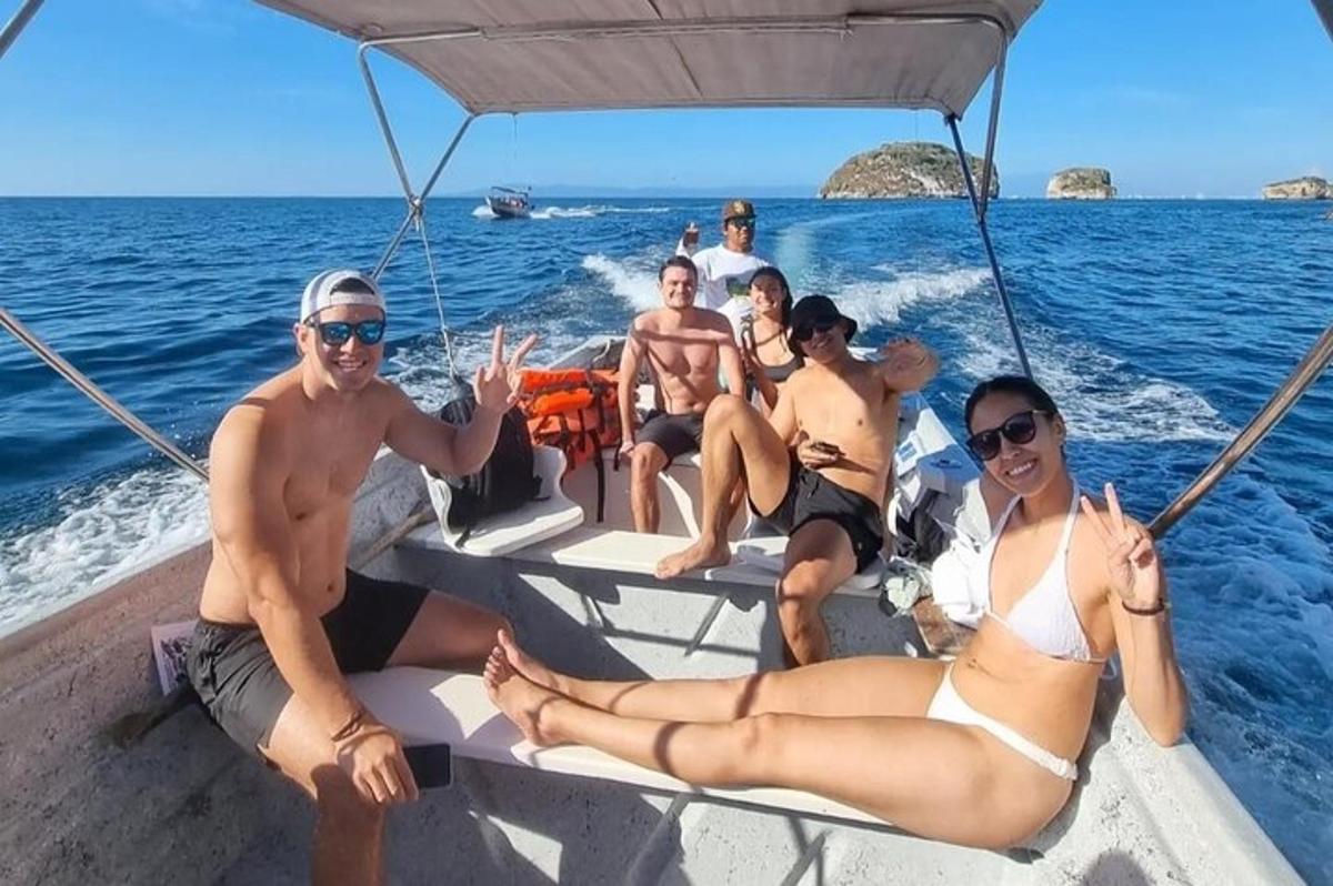 a group of people sitting on a boat in the ocean