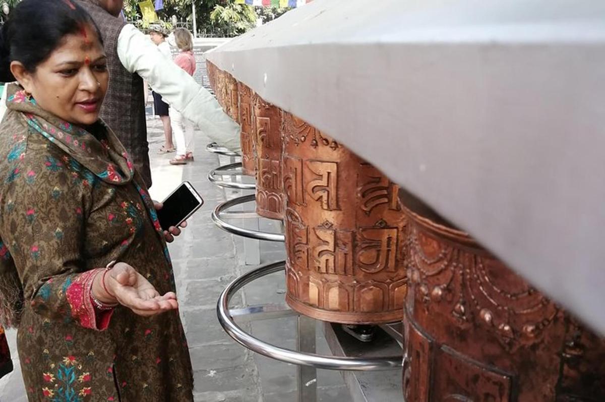 a woman standing next to a large wooden artifact