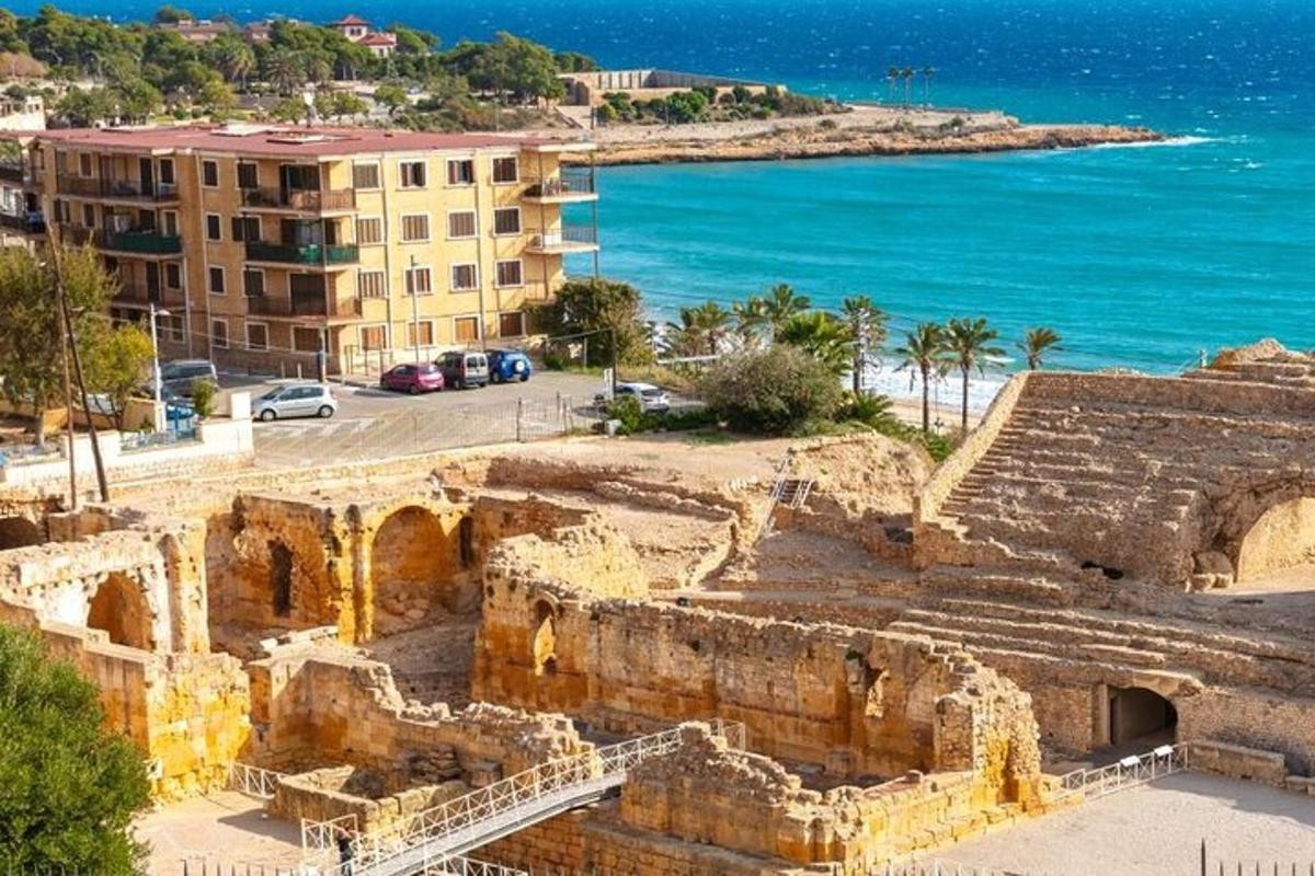 a view of the ruins of a building and the ocean