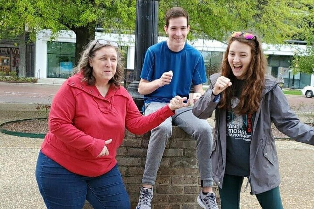 a group of three people standing on a wall