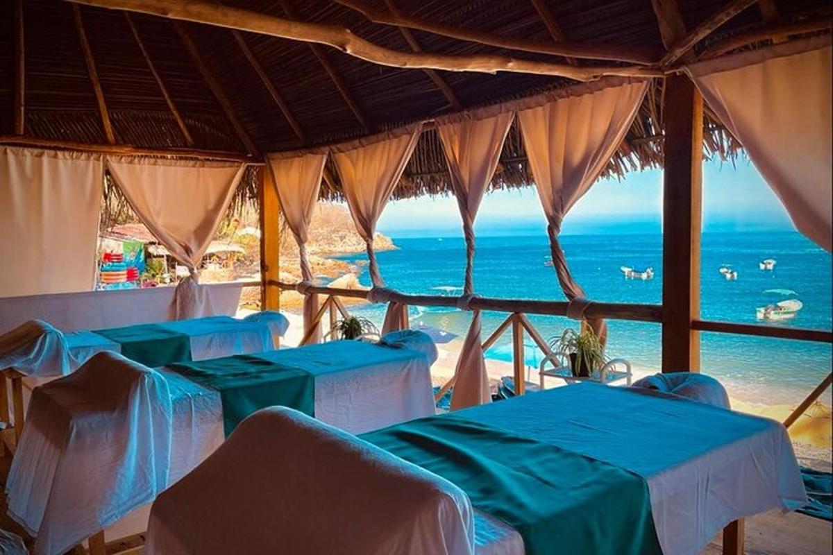 a room with tables and a view of the ocean