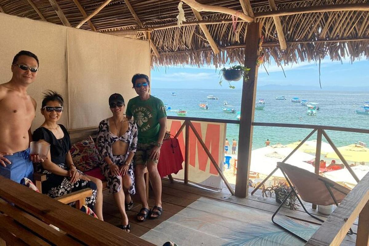 a group of people posing for a picture at the beach