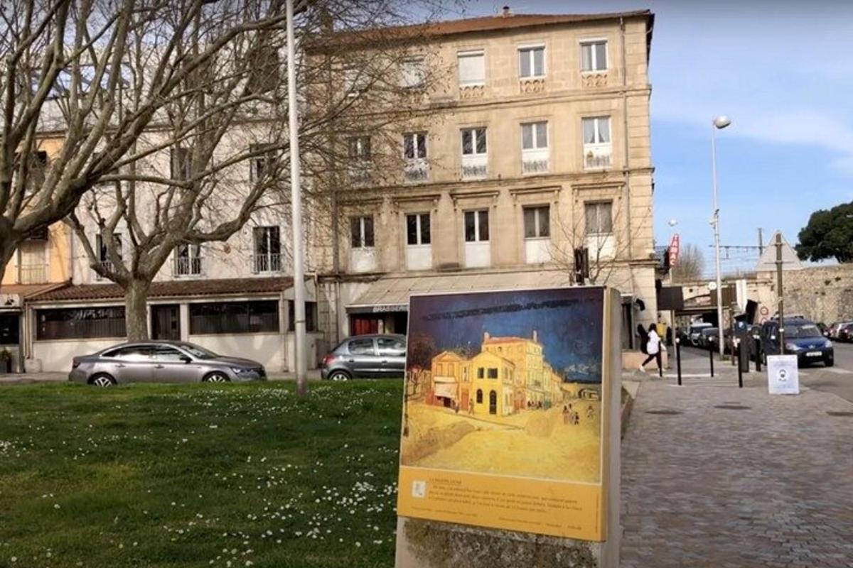 a sign with a picture of a building in front of a building