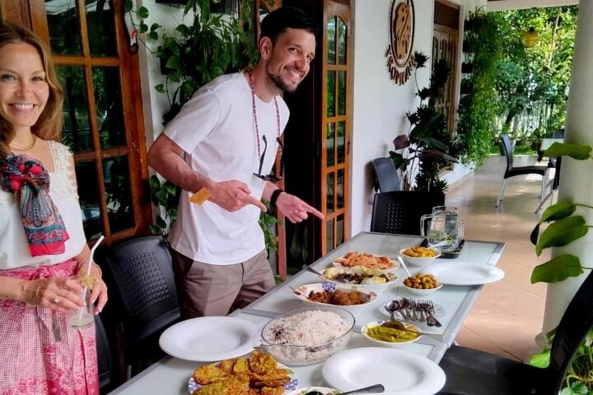 a man and a woman standing next to a table with food