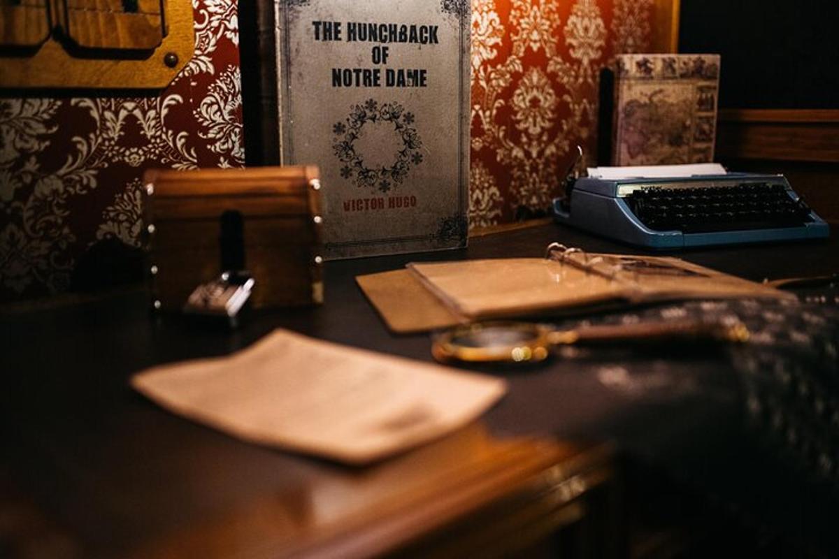a desk with a book and a keyboard and a phone