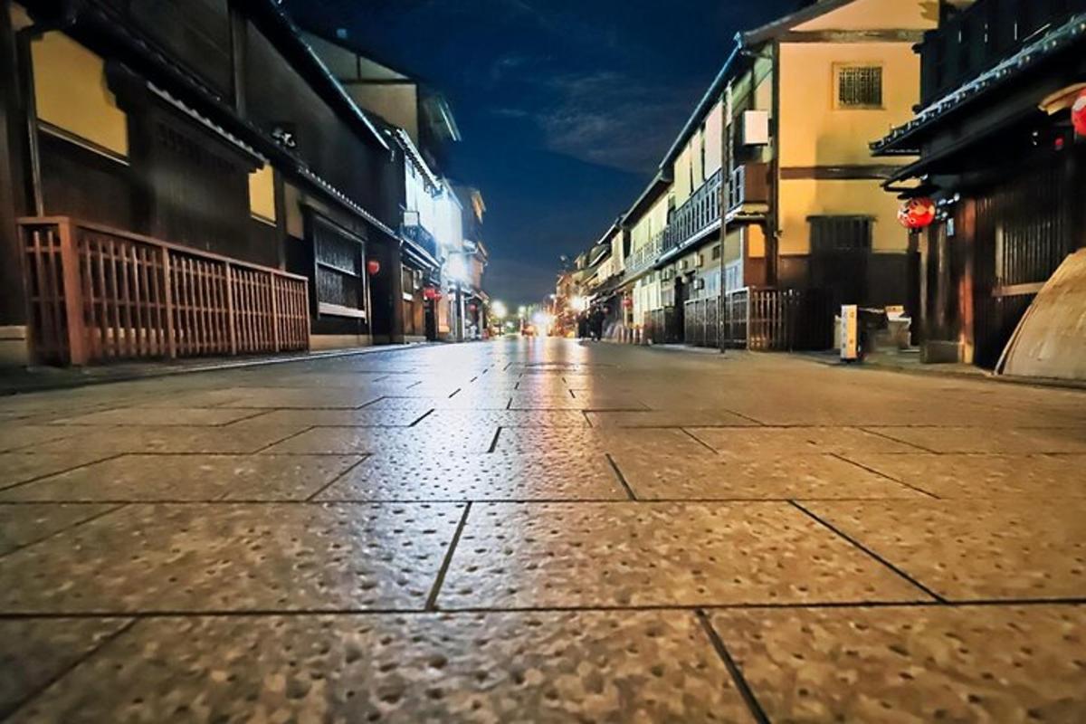 an empty city street at night with buildings