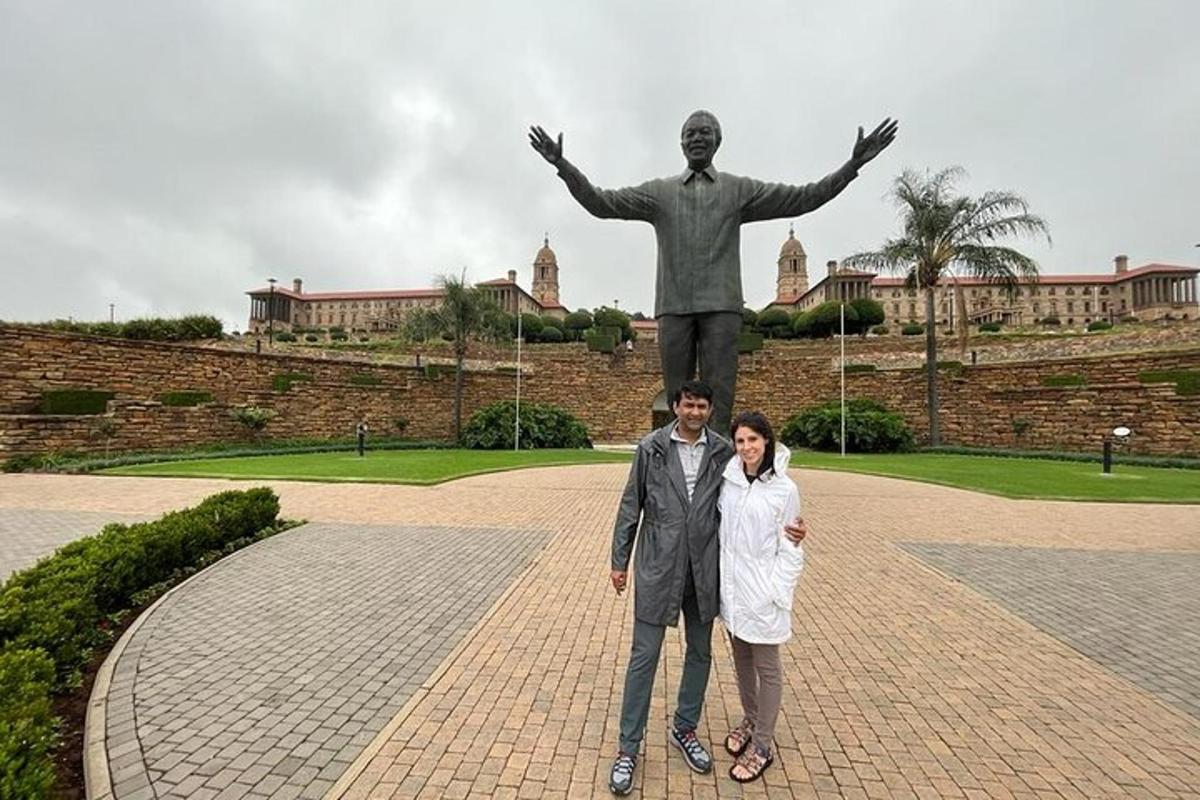 a man and a woman standing in front of a statue