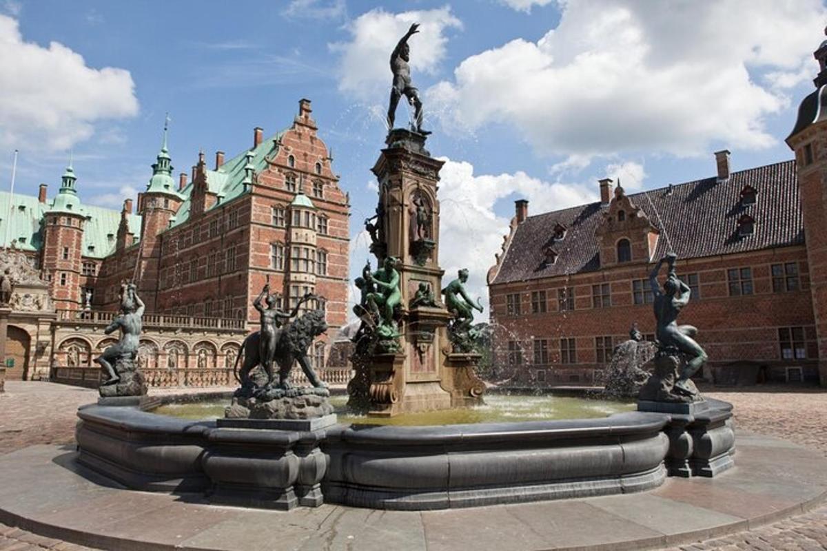 a fountain in front of a building with a statue