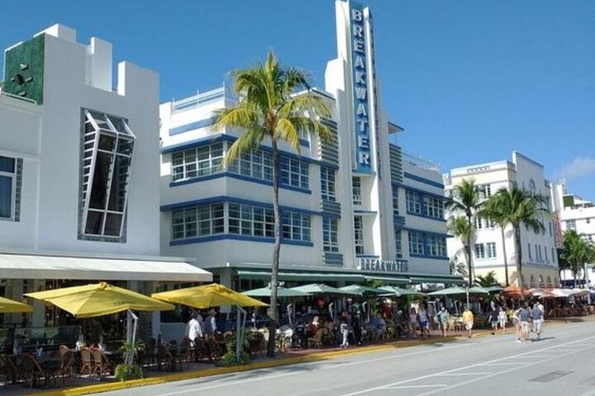 a building with tables and umbrellas on a city street