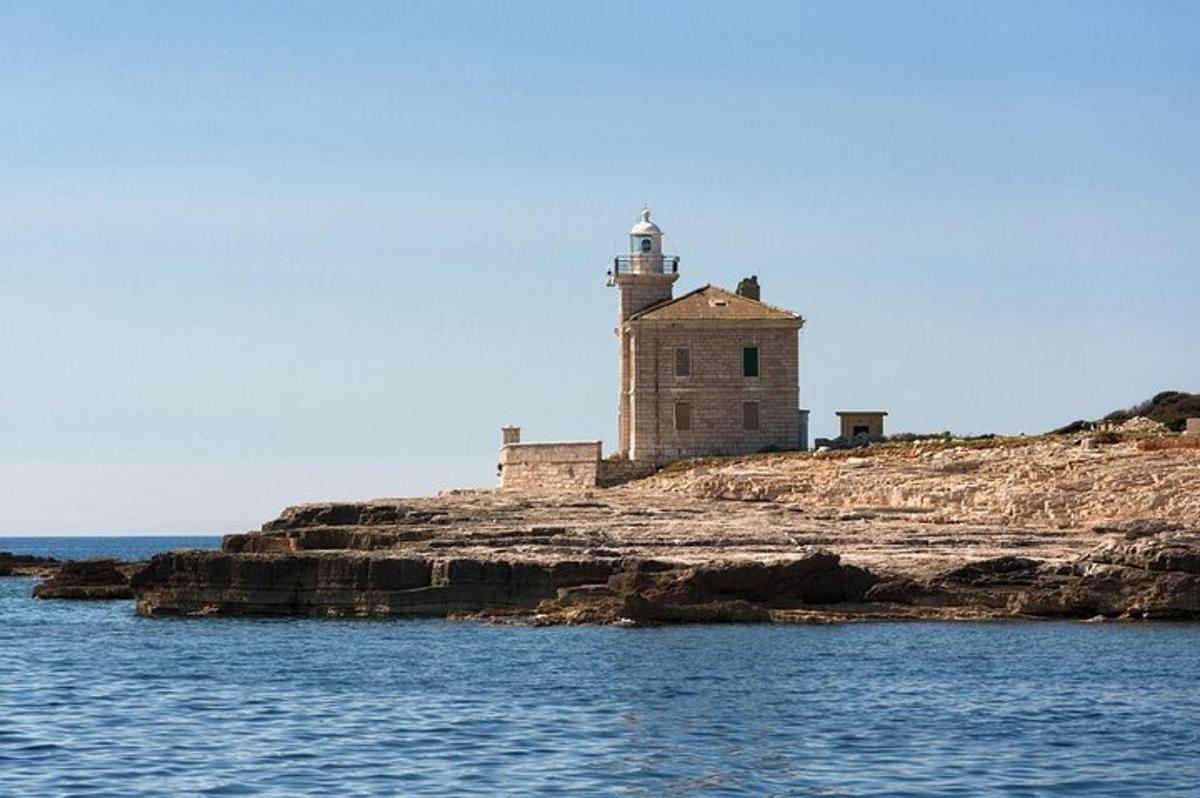 a lighthouse on a rocky island in the water