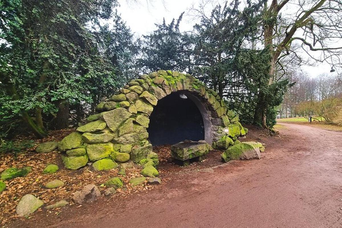 a stone bridge on the side of a dirt road