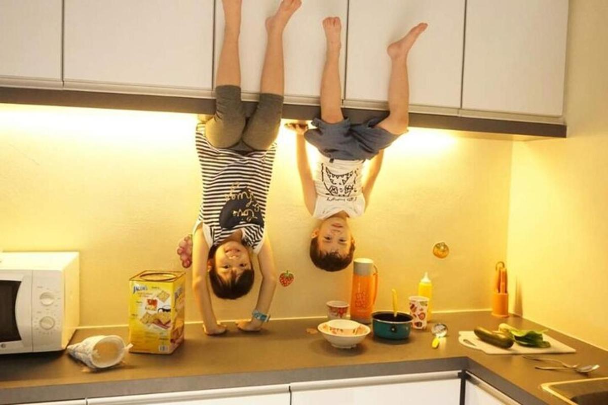 three people hanging on a wall in a kitchen