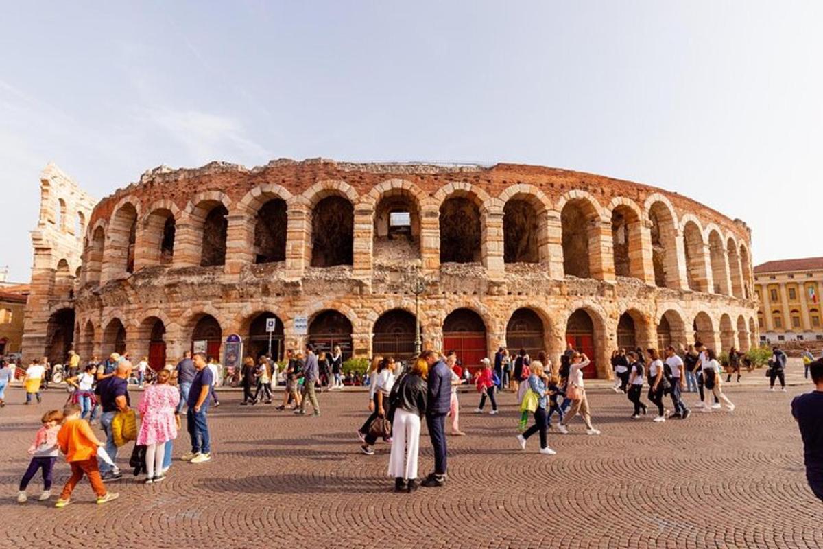 a large group of people walking around the coliseum