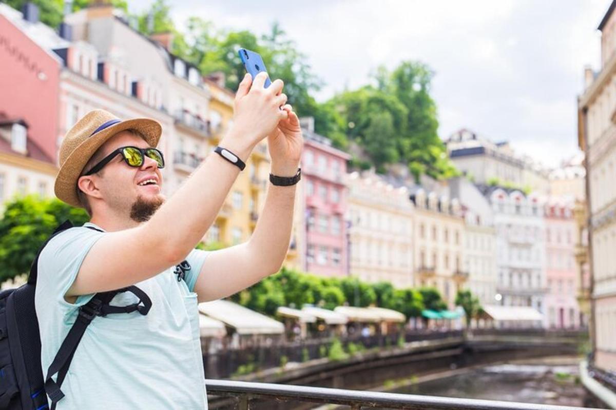 a man taking a picture of a city with his cell phone