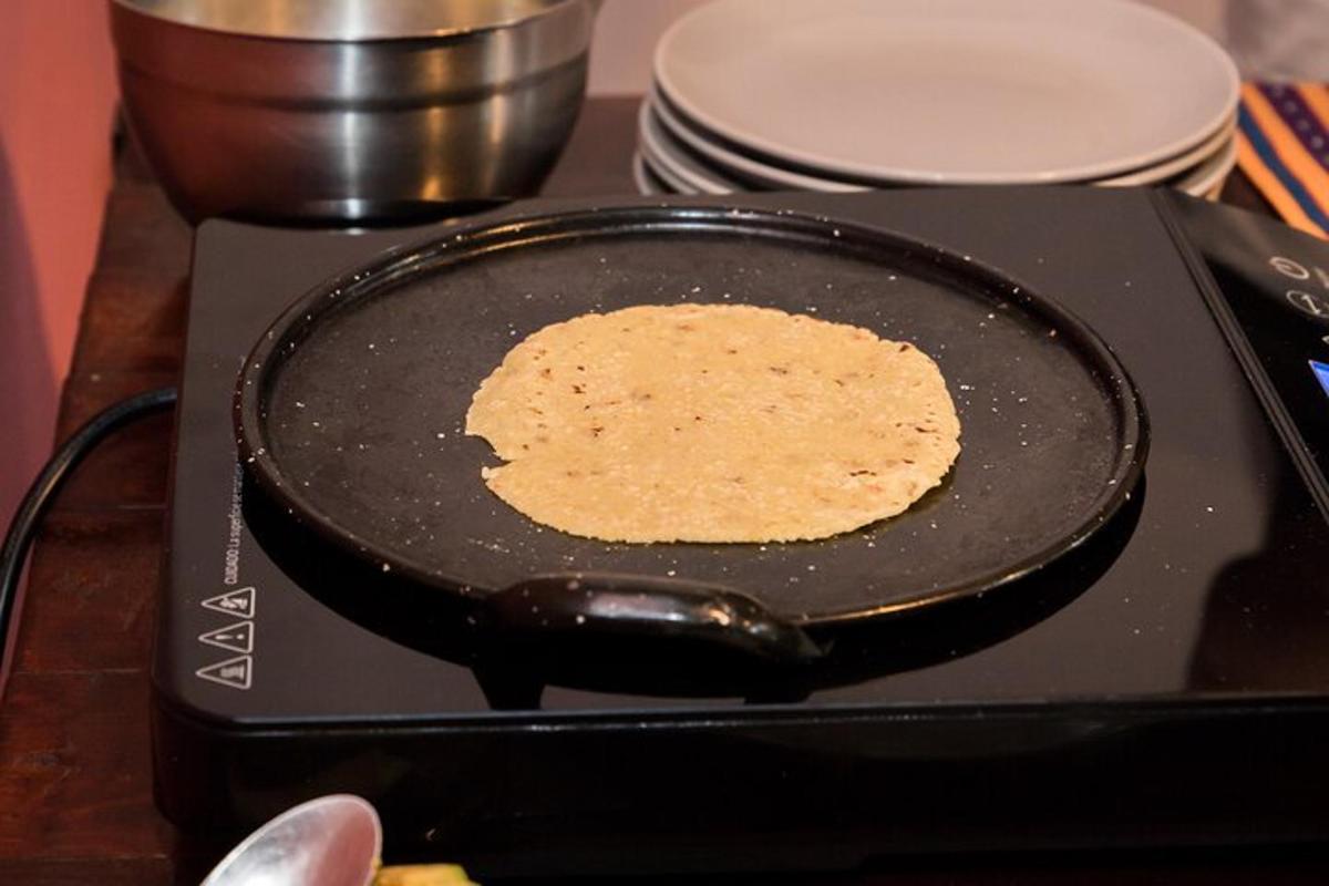 a pancake is being fried in a pan on a stove