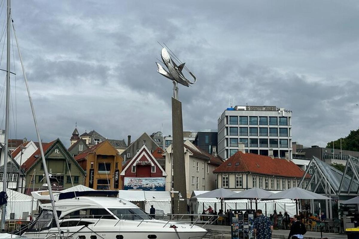 a statue of a plane on a pole in a harbor