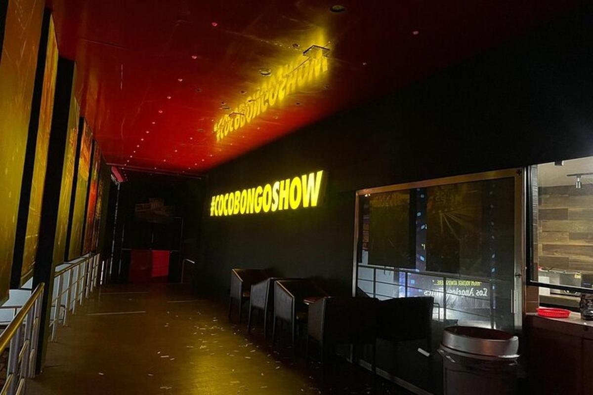 a restaurant with a neon sign on the wall