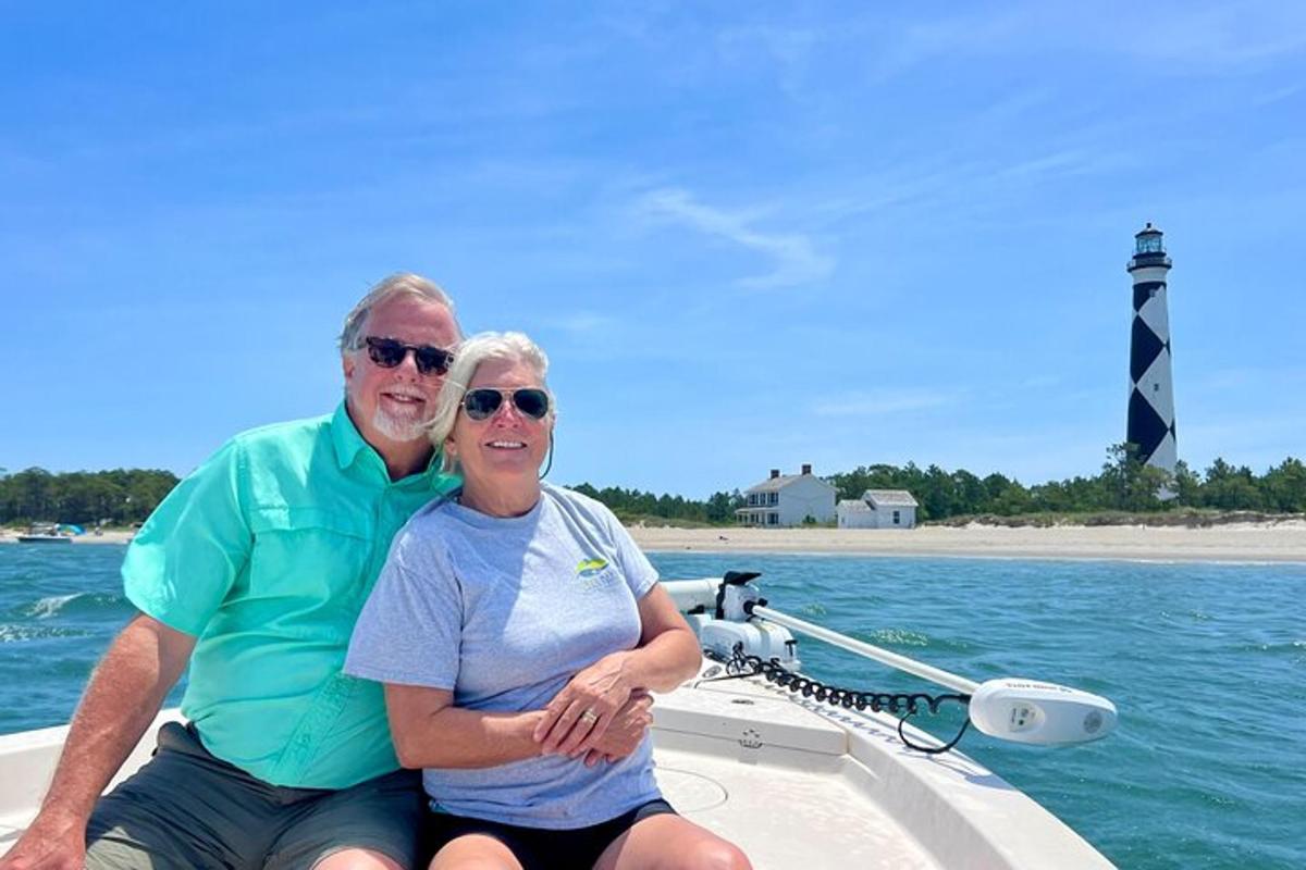 a man and woman sitting on a boat in the water