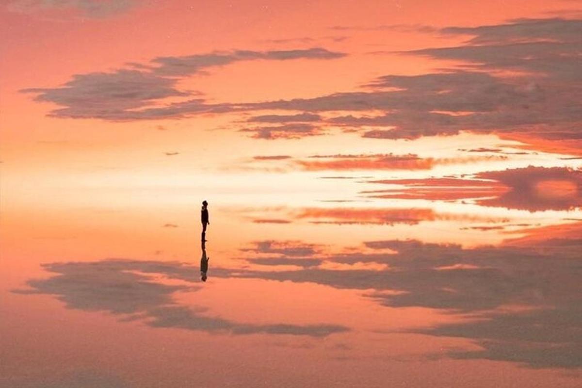 a person standing on a pole in the clouds