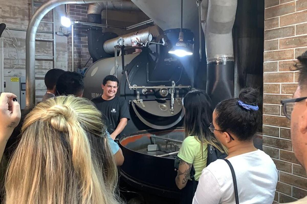 a group of people standing around a man in a machine