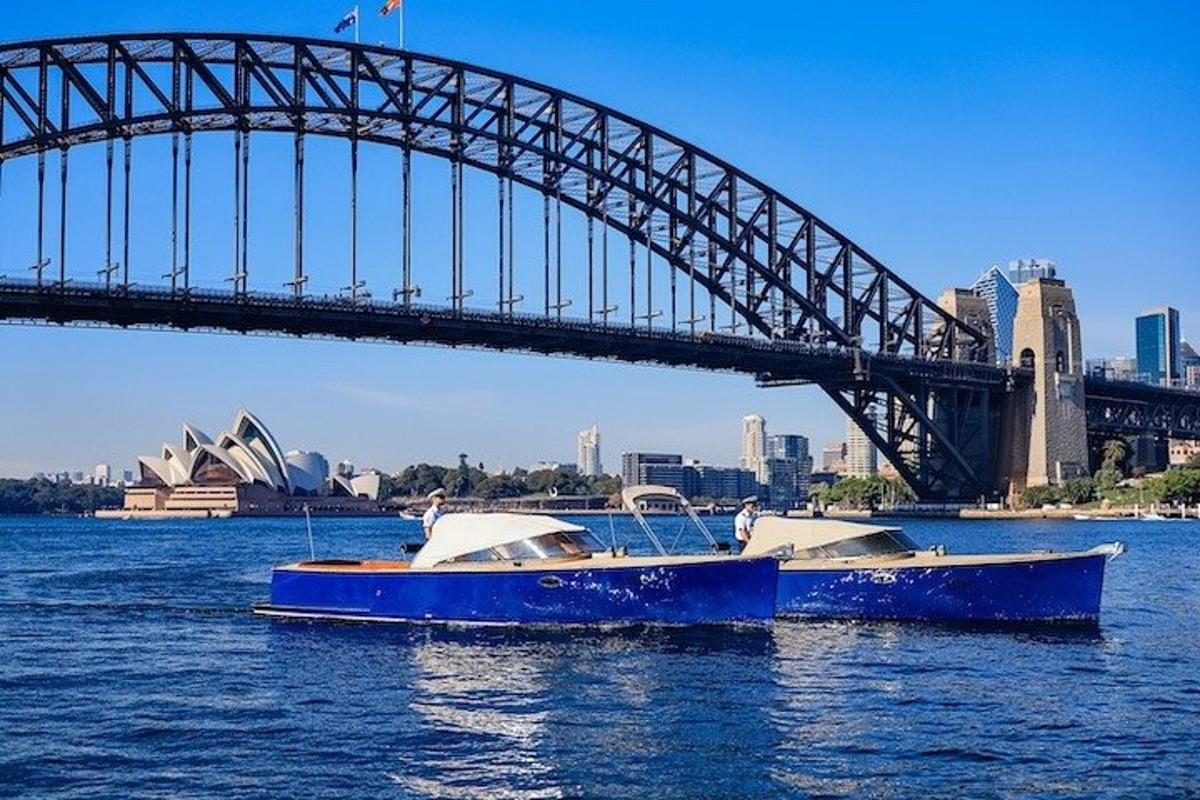 two boats in the water in front of a bridge