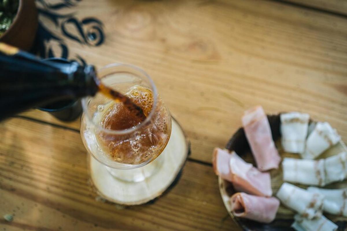 a drink with a piece of cheese and a piece of meat