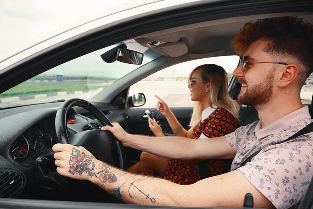 a man and a woman sitting in a car