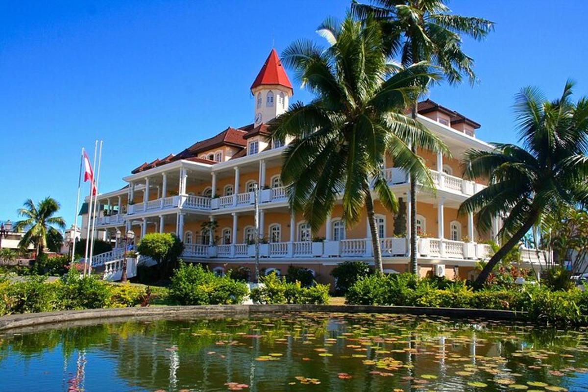 a large building with a pond in front of it