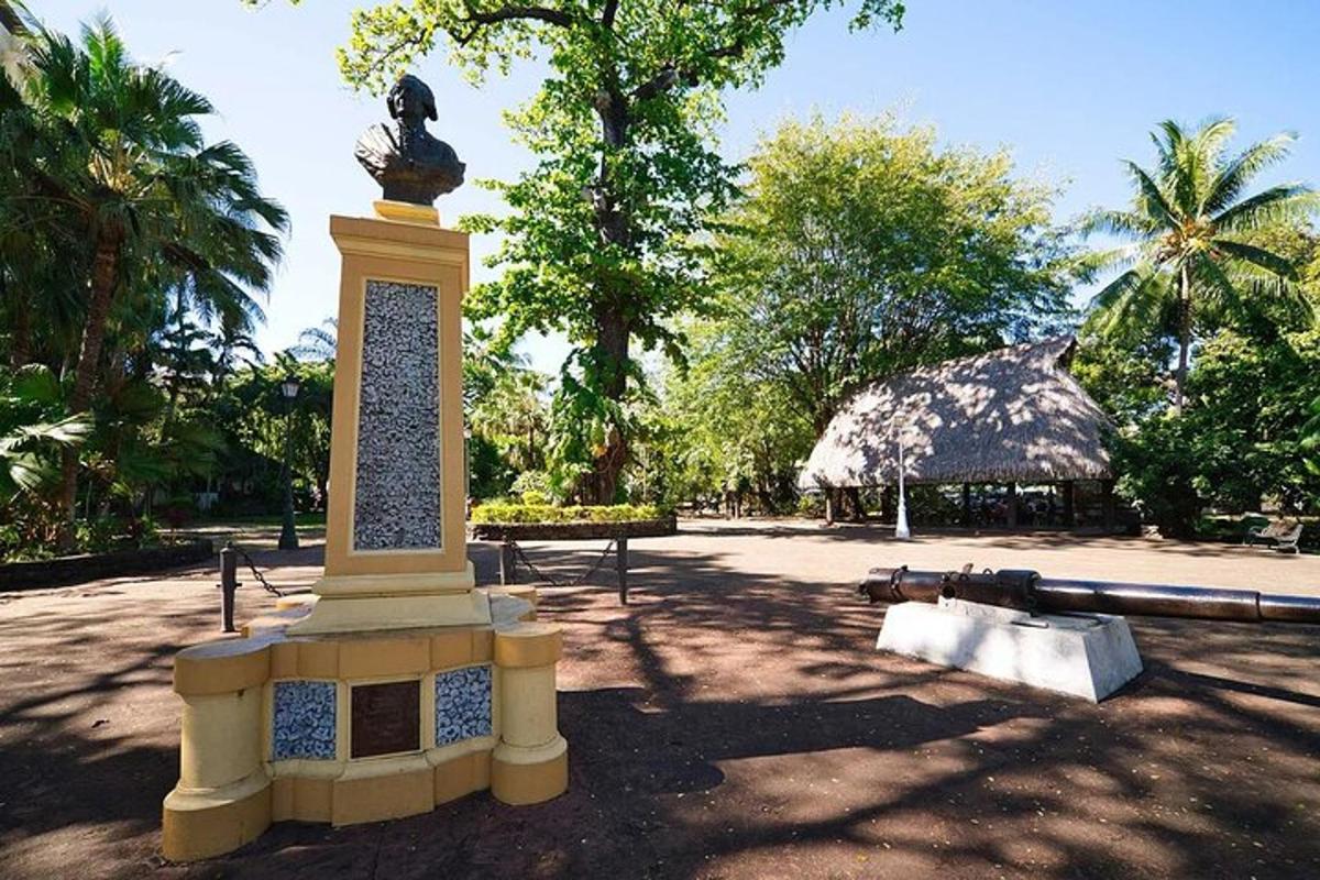 a statue on top of a monument in a park