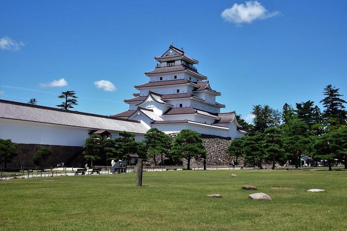 a large building with a grass field in front of it