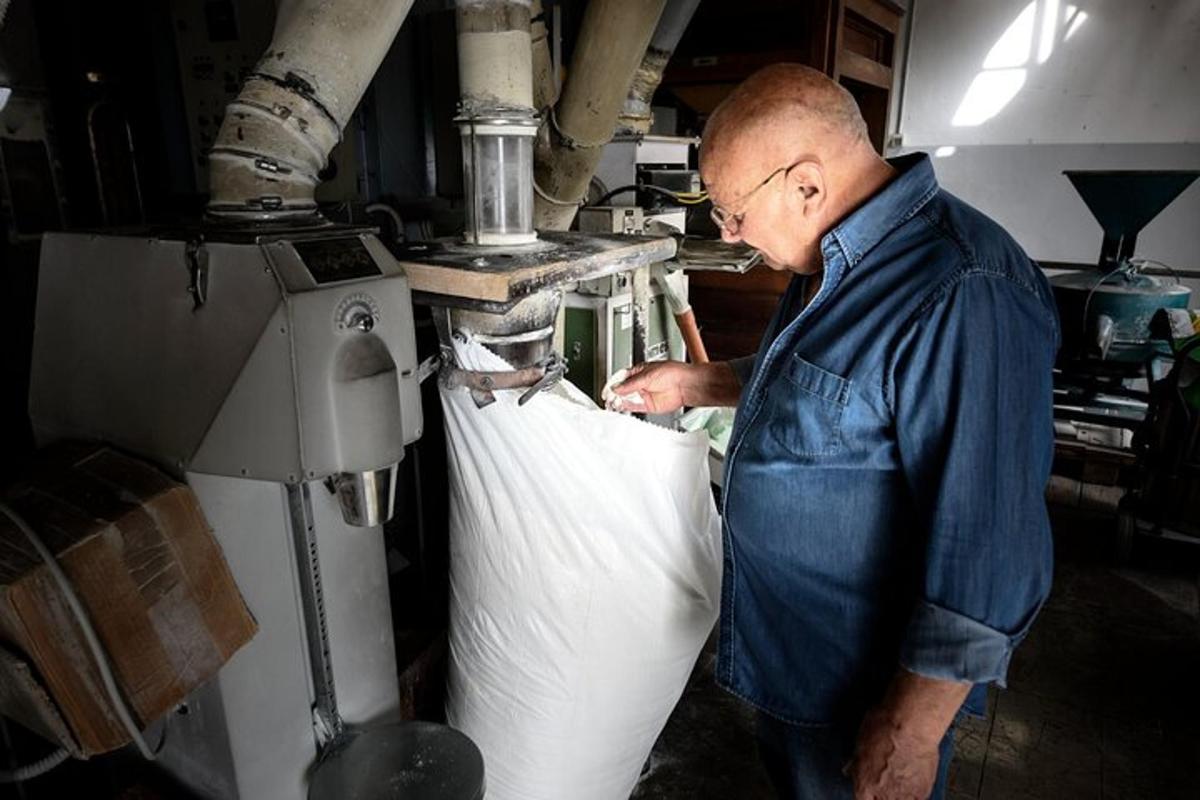 a man is making a piece of cloth in a machine