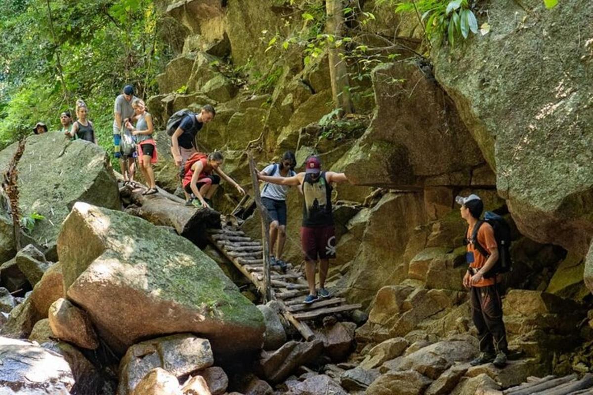 a group of people walking on a rocky trail