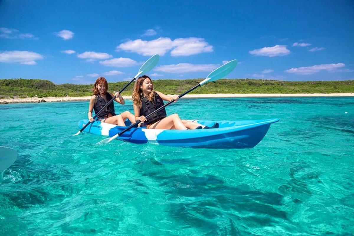 two girls are sitting in a kayak in the water